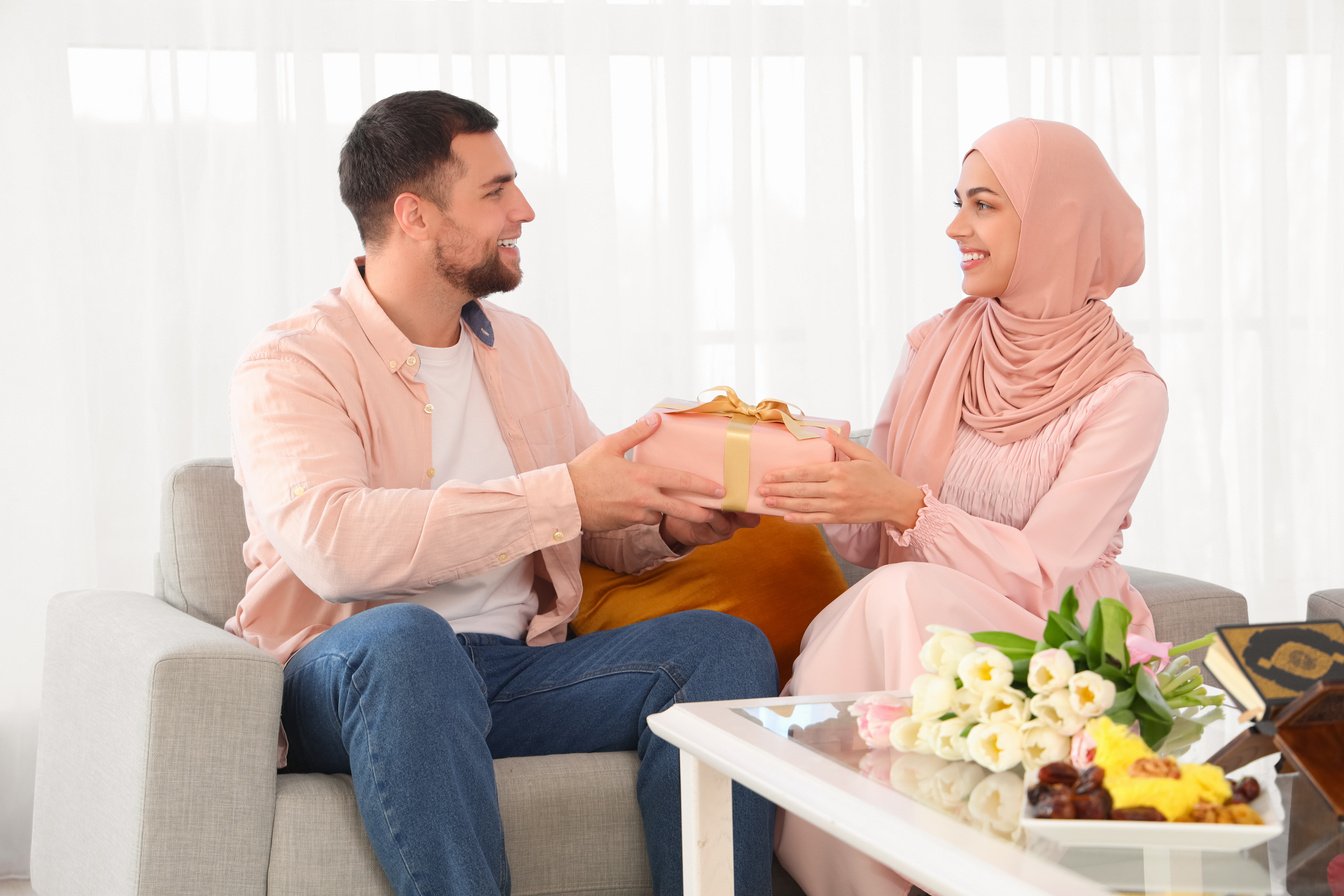 Happy Muslim Couple with Gift Box at Home. Ramadan Celebration