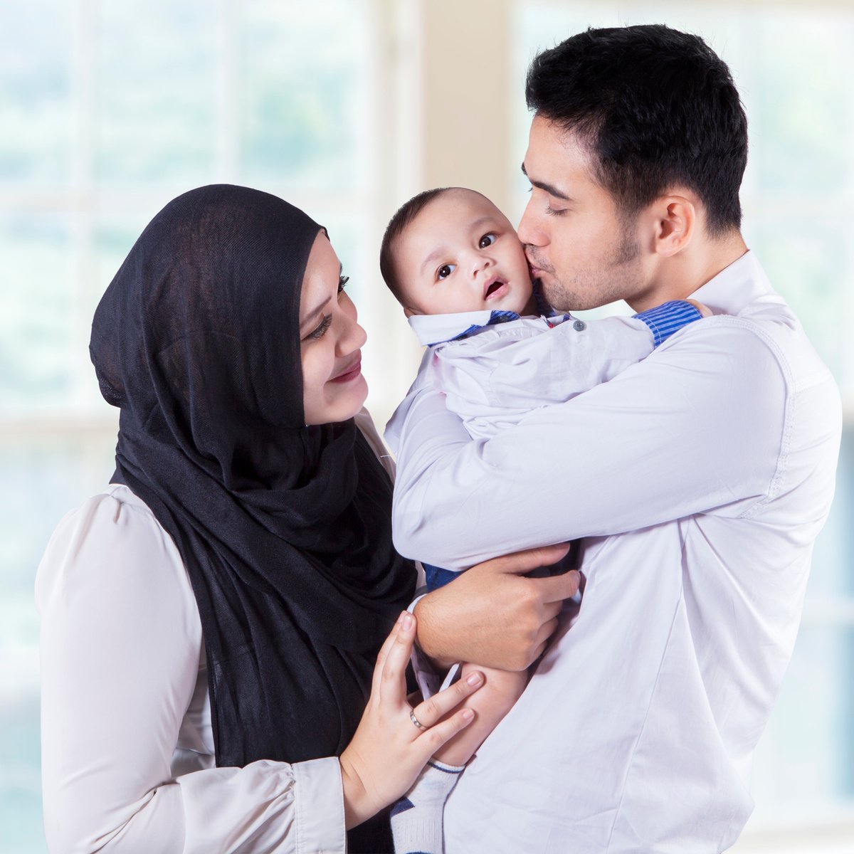 Muslim Family Standing near the Window